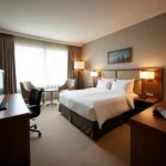 Modern hotel room with amenities, ideal for travelers near LKO Airport.