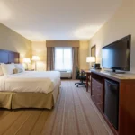 Modern hotel room with comfortable bed and work desk