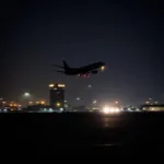 Jaipur Airport at Night with Plane Taking Off