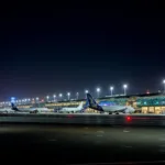 Dubai International Airport illuminated at night