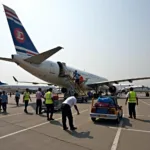 Ground staff loading luggage onto an aircraft at Kolkata Airport.