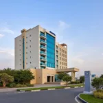 Novotel Muscat Airport Exterior: Modern Architecture and Lush Landscaping