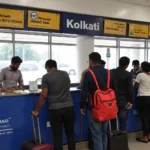 Passengers queuing at the pre-paid taxi counter at Kolkata Airport.