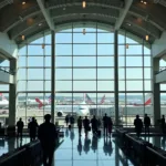 Washington National Airport terminal with bustling passengers and planes.