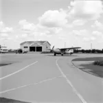 ABM Miami International Airport: A historical photograph depicting the early days of the airport, showcasing the original terminal building and aircraft.